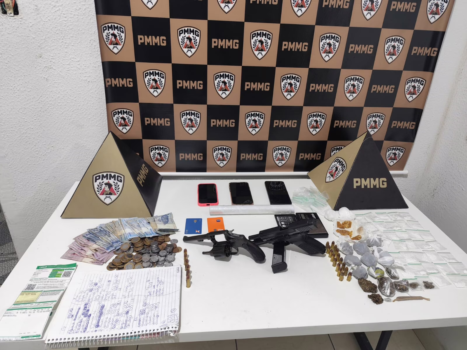 Ao mesmo tempo, os ocupantes da motocicleta também foram abordados. No interior de uma bolsa usada para armazenar os ilícitos, foram localizadas quatro pedras de substância análoga a crack, porções de maconha e cocaína, além de outros materiais relacionados ao tráfico.