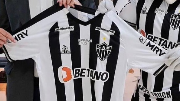presidente do galo segurando a camisa do clube junto com o mascote